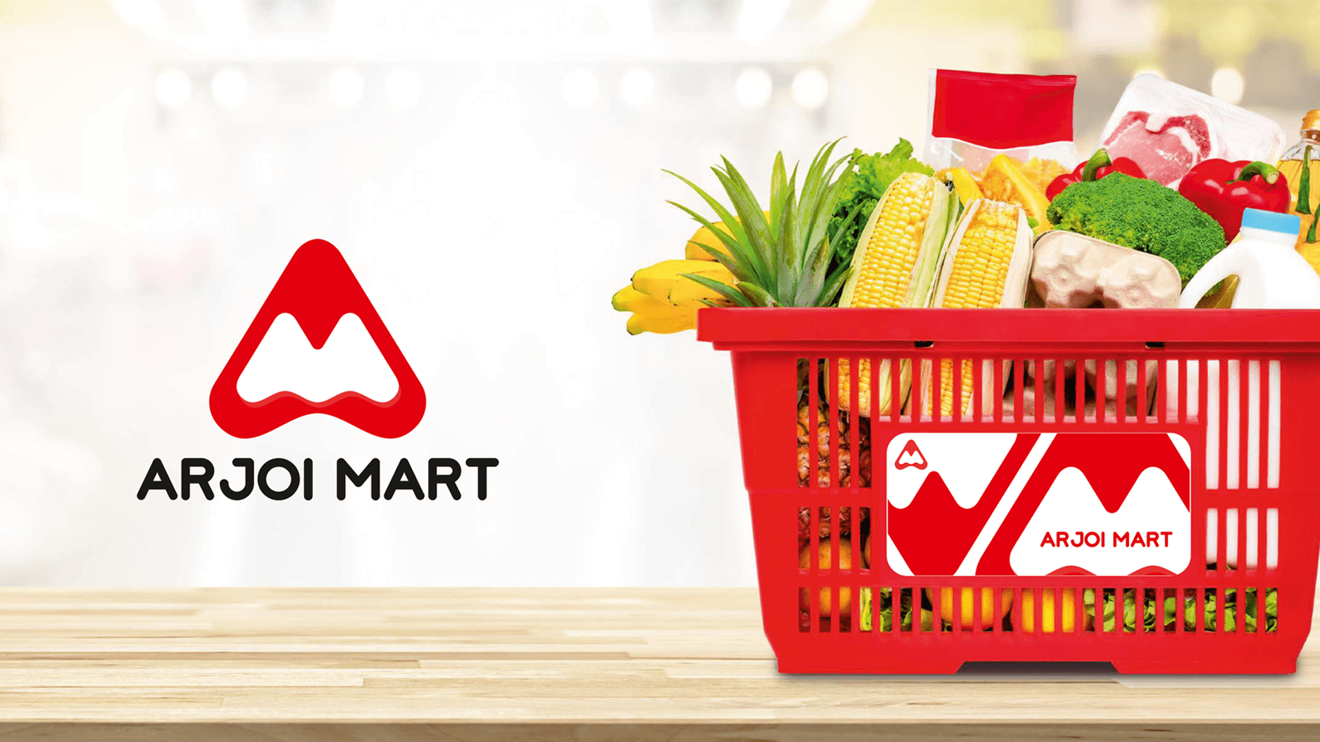 Arjoi Mart hero — logo lockup with overflowing red grocery basket on wooden surface
