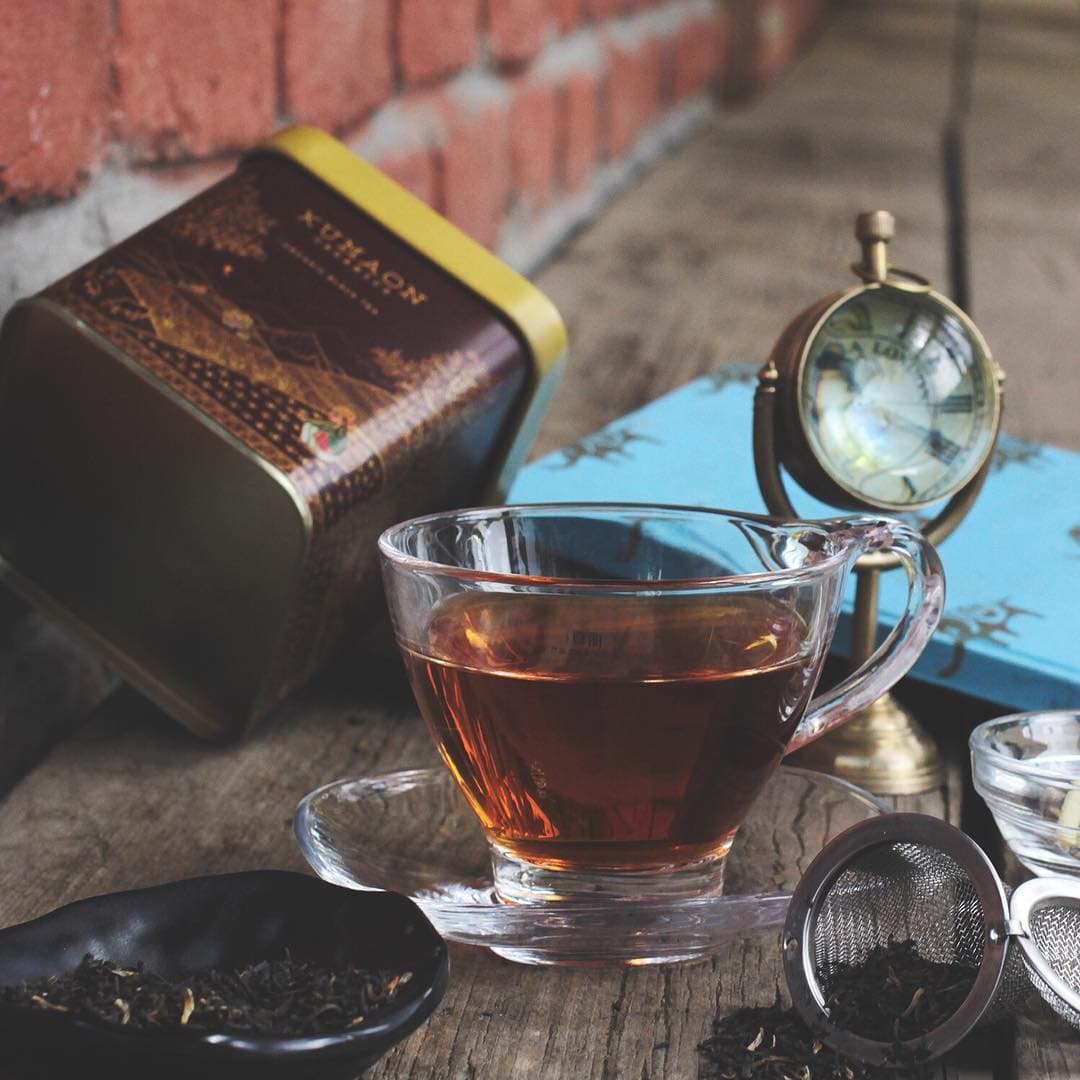 Kumaon Organics black tea tin with brewed tea